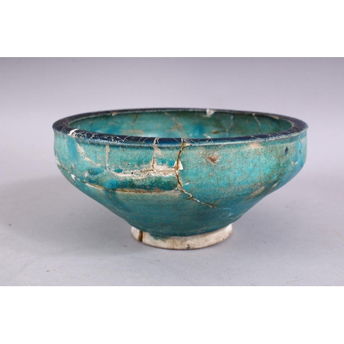 701 - AN EARLY PERSIAN OTTOMAN TURQUOISE GLAZED POTTERY BOWL (repairs and restoration), 19cm diameter.