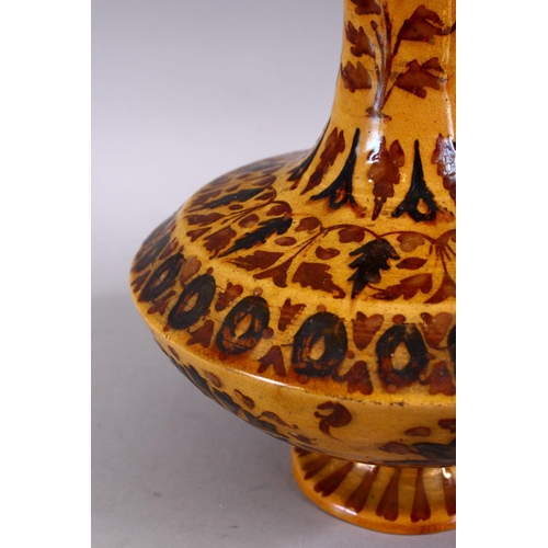 702 - AN ISLAMIC POTTERY VASE, with bands of floral decoration, 25cm high.