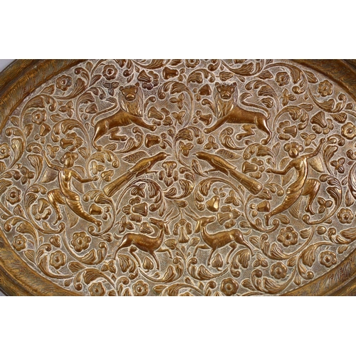 703 - A GOOD EARLY 20TH CENTURY OVAL TRAY embossed with lions, figures and birds, 39cm wide. Together with... 