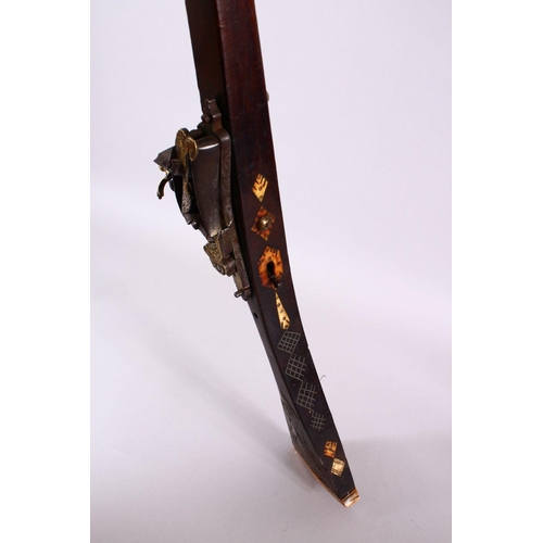 714 - A LONG 19TH CENTURY NORTH AFRICAN RIFLE, with gilt metal mounts, octagonal barrel, with bone and sil... 