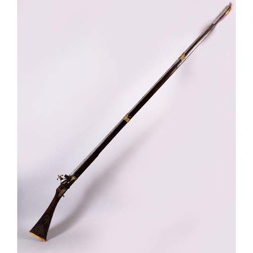 714 - A LONG 19TH CENTURY NORTH AFRICAN RIFLE, with gilt metal mounts, octagonal barrel, with bone and sil... 