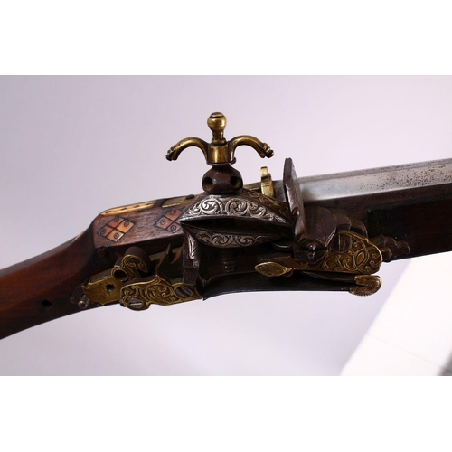 714 - A LONG 19TH CENTURY NORTH AFRICAN RIFLE, with gilt metal mounts, octagonal barrel, with bone and sil... 