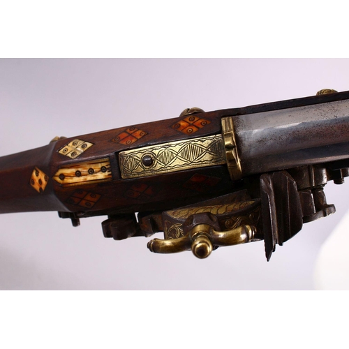 714 - A LONG 19TH CENTURY NORTH AFRICAN RIFLE, with gilt metal mounts, octagonal barrel, with bone and sil... 