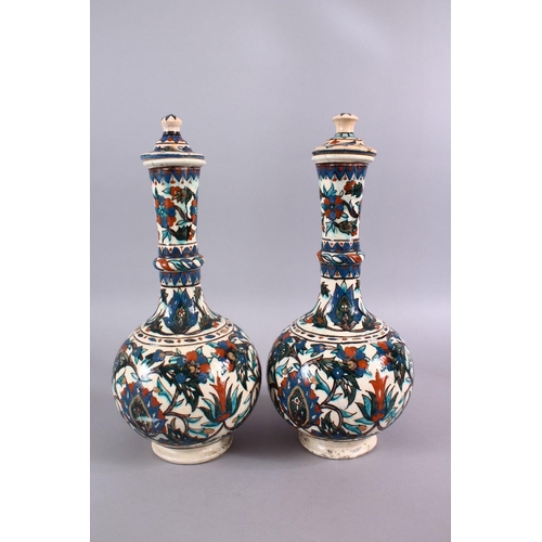 719 - A LARGE PAIR OF 19TH CENTURY OTTOMAN TURKISH KUTAHIYA LIDDED PORCELAIN BOTTLE VASES,each with floral... 