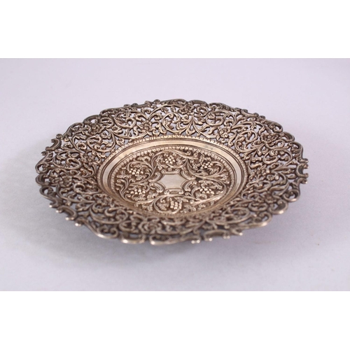 723 - A 19TH CENTURY INDIAN SILVER OPEN WORKED DISH, with formal floral decoration and openwork, 18cm.