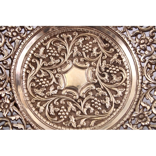 723 - A 19TH CENTURY INDIAN SILVER OPEN WORKED DISH, with formal floral decoration and openwork, 18cm.