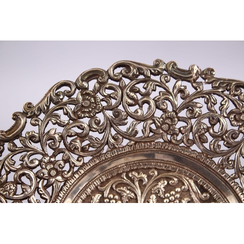 723 - A 19TH CENTURY INDIAN SILVER OPEN WORKED DISH, with formal floral decoration and openwork, 18cm.