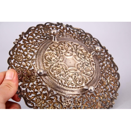 723 - A 19TH CENTURY INDIAN SILVER OPEN WORKED DISH, with formal floral decoration and openwork, 18cm.