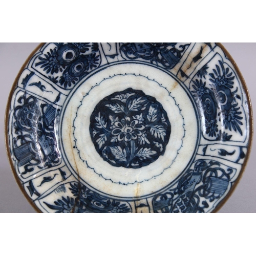 725 - A 17TH CENTURY PERSIAN SAFAVID BLUE AND WHITE DISH, decorated with precious objects and native flora... 