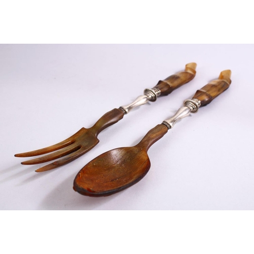 73 - A 19TH CENTURY RHINOCEROS HORN & SILVER SALAD SERVING SPOONS, 30cm.