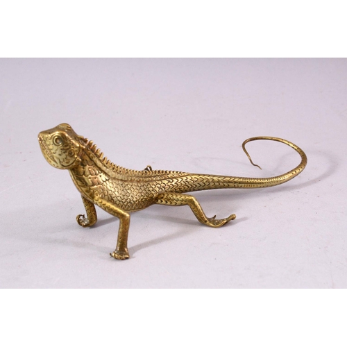 739 - A SMALL POLISHED BRASS LIZARD, 17cm long.