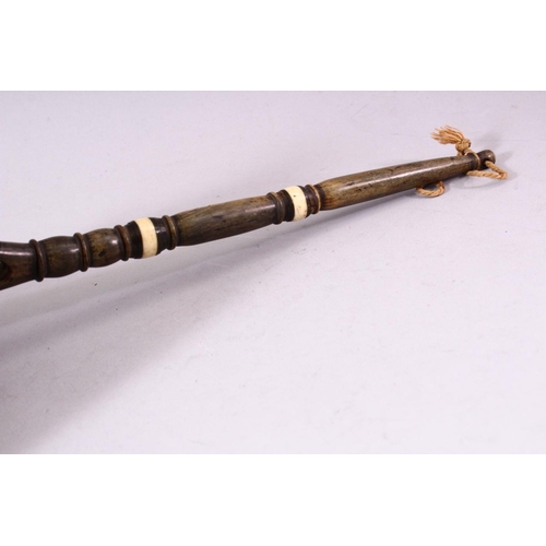 741 - AN UNUSUAL 19TH CENTURY COCONUT WATER SCOOP, with horn handle and bone inlaid decoration, 33cm long.