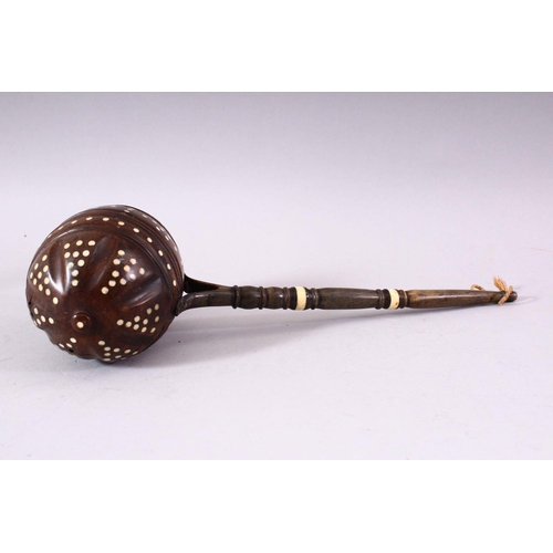 741 - AN UNUSUAL 19TH CENTURY COCONUT WATER SCOOP, with horn handle and bone inlaid decoration, 33cm long.