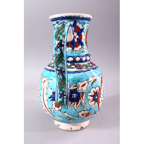 742 - A 19TH CENTURY KUTAHYA JUG, decorated in the Iznik taste, 26cm high.