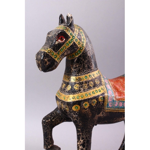 751 - A KASHMIRI PAINTED CARVED WOOD MODEL OF A PRANCING HORSE, 38cm long