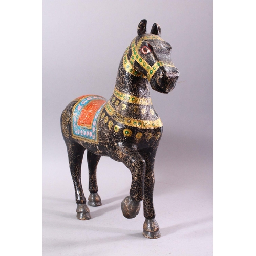 751 - A KASHMIRI PAINTED CARVED WOOD MODEL OF A PRANCING HORSE, 38cm long