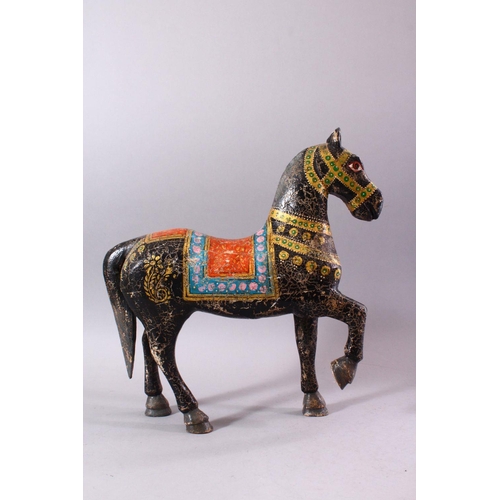 751 - A KASHMIRI PAINTED CARVED WOOD MODEL OF A PRANCING HORSE, 38cm long