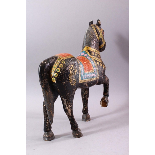 751 - A KASHMIRI PAINTED CARVED WOOD MODEL OF A PRANCING HORSE, 38cm long