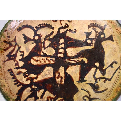 759 - A GOOD EARLY ISLAMIC POTTERY DISH, decorated with animals (AF), 33cm,