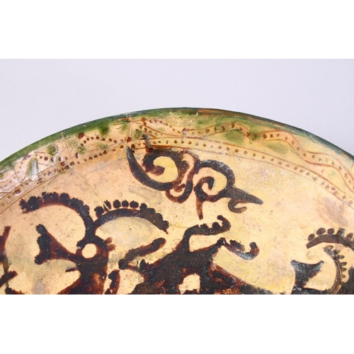 759 - A GOOD EARLY ISLAMIC POTTERY DISH, decorated with animals (AF), 33cm,