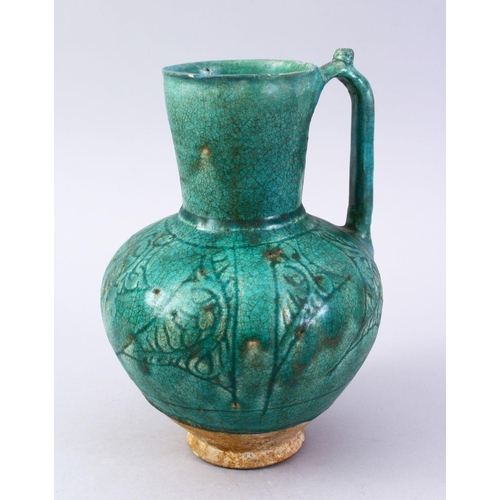 762 - A GOOD EARLY ISLAMIC TURQUOISE GLAZED POTTERY JUG, 22cm high.