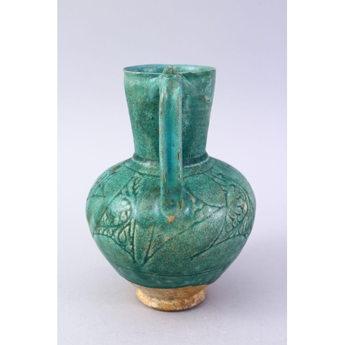 762 - A GOOD EARLY ISLAMIC TURQUOISE GLAZED POTTERY JUG, 22cm high.