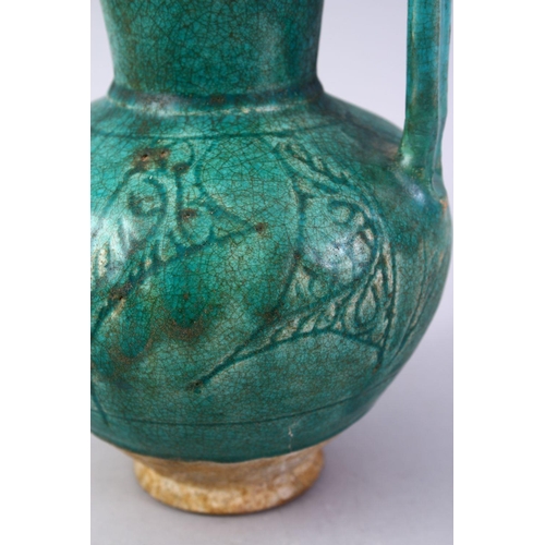 762 - A GOOD EARLY ISLAMIC TURQUOISE GLAZED POTTERY JUG, 22cm high.