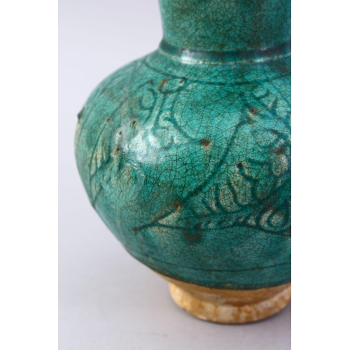 762 - A GOOD EARLY ISLAMIC TURQUOISE GLAZED POTTERY JUG, 22cm high.