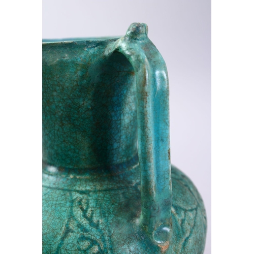 762 - A GOOD EARLY ISLAMIC TURQUOISE GLAZED POTTERY JUG, 22cm high.