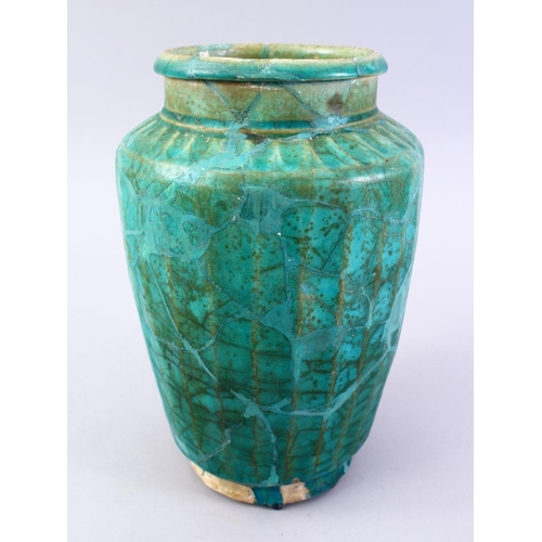 765 - A LARGER ISLAMIC TURQUOISE GLAZED POTTERY VASE, with a ribbed body, 29cm high.