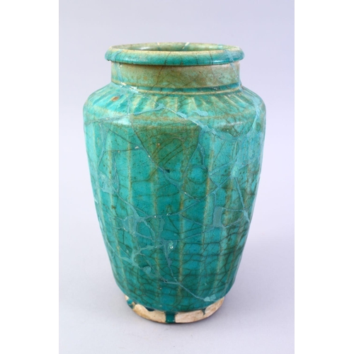 765 - A LARGER ISLAMIC TURQUOISE GLAZED POTTERY VASE, with a ribbed body, 29cm high.