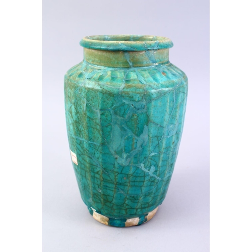 765 - A LARGER ISLAMIC TURQUOISE GLAZED POTTERY VASE, with a ribbed body, 29cm high.