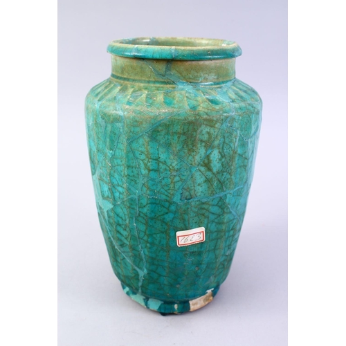 765 - A LARGER ISLAMIC TURQUOISE GLAZED POTTERY VASE, with a ribbed body, 29cm high.