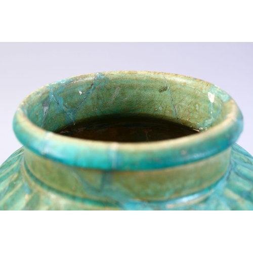 765 - A LARGER ISLAMIC TURQUOISE GLAZED POTTERY VASE, with a ribbed body, 29cm high.