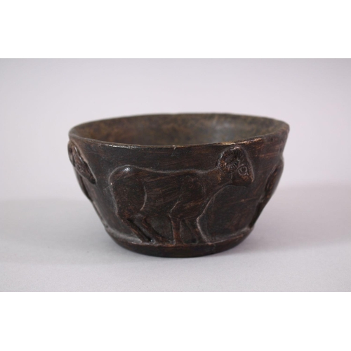 766 - AN EARLY SUMERIAN POTTERY RAM BOWL, with relief carved rams, 13cm