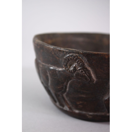 766 - AN EARLY SUMERIAN POTTERY RAM BOWL, with relief carved rams, 13cm