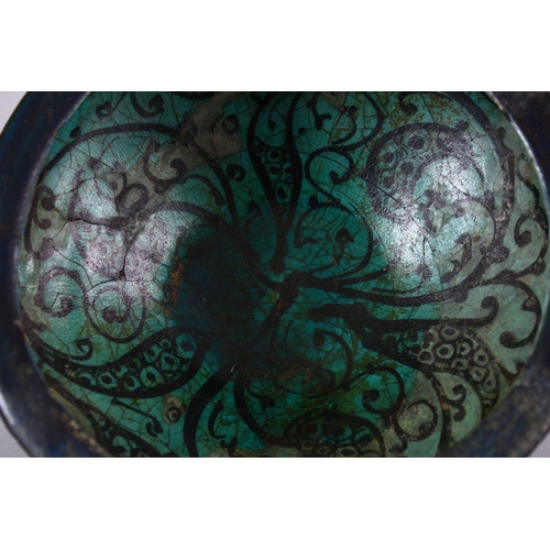 774 - AN EARLY PERSIAN TURQUOISE POTTERY BOWL, decorated with floral motif, 19cm (af)