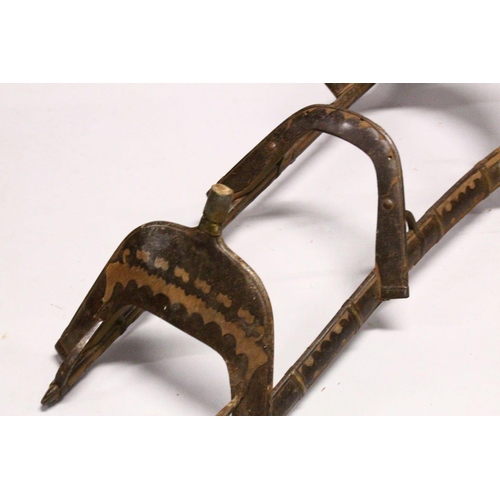 779 - A LARGE WOOD & METAL POSSIBLY EGYPTIAN CAMEL SADDLE / SEAT, the timbers enclosed and decorated with ... 