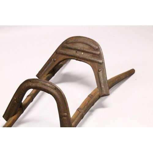 780 - A LARGE WOOD & METAL POSSIBLY EGYPTIAN CAMEL SADDLE / SEAT, the timbers enclosed and decorated with ... 