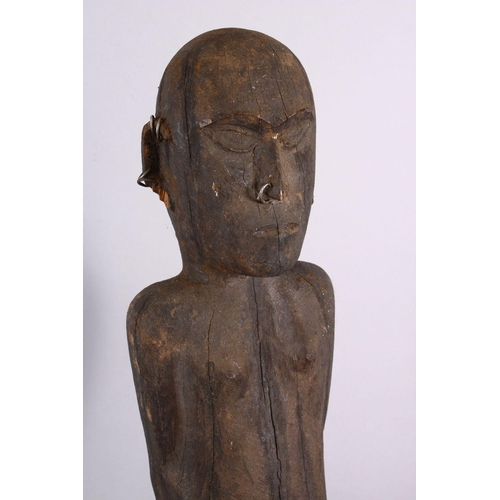 785 - AN AFRICAN CARVED WOODEN NATIVE FIGURE, with piercing's, 80cm.