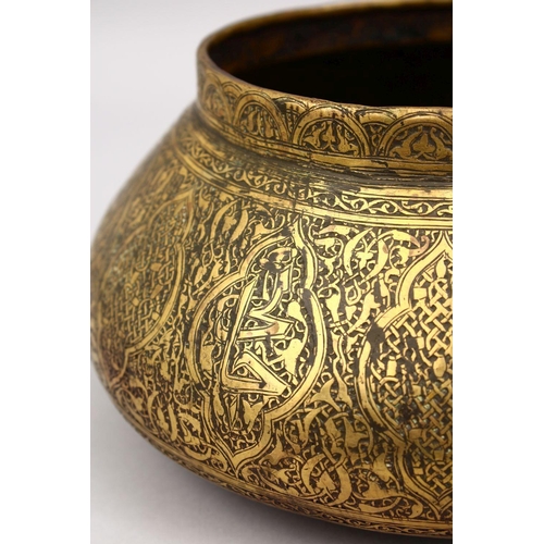 794 - A GOOD 19TH CENTURY DAMASCUS BRASS CARVED BOWL, the bowl carved with formal floral motif, 25cm.