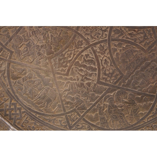 795 - A GOOD ISLAMIC QAJAR CARVED BRONZE MOULDED DISH, With decoration of figures and animals, and bands o... 