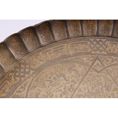 795 - A GOOD ISLAMIC QAJAR CARVED BRONZE MOULDED DISH, With decoration of figures and animals, and bands o... 