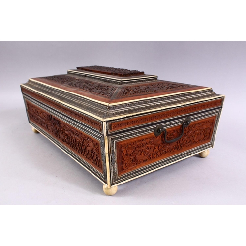 797 - A 19TH CENTURY ANGLO INDIAN INLAID LIDDED SEWING BOX, with carved wood depicting figures and animals... 