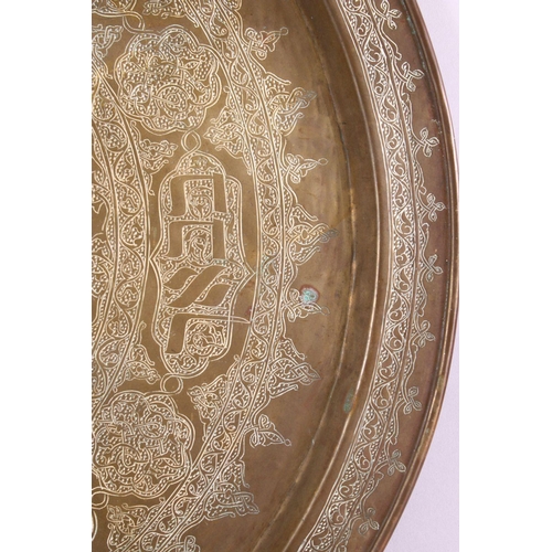 801 - A LARGE BRASS JEWISH CALLIGRAPHIC CHARGER, carved with hebrew script in panels, 55cm.