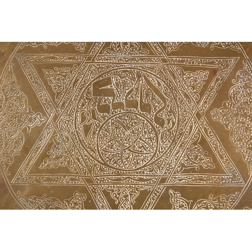 801 - A LARGE BRASS JEWISH CALLIGRAPHIC CHARGER, carved with hebrew script in panels, 55cm.