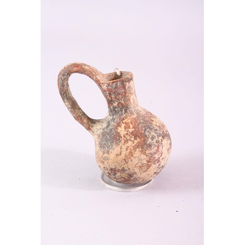 810 - A SMALL COLLECTION OF EXCAVATED POTTERY ITEMS, comprising four teracotta jugs, two small twin handle... 