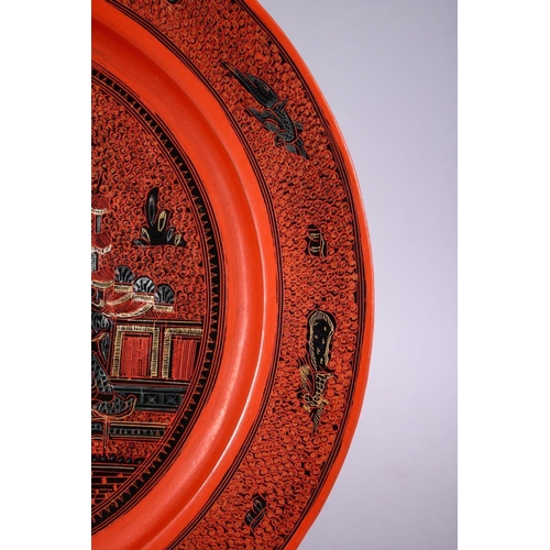 812 - A 19TH / 20TH CENTURY INDIAN LACQUER PLATE, with scenes of figures and buildings, 26cm