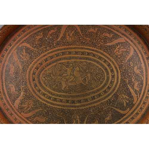 814 - A HEAVY QUALITY CARVED PERSIAN BRASS TRAY, carved with scenes of figures and animals and flora, 43.5... 