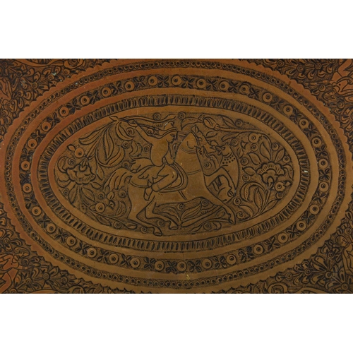 814 - A HEAVY QUALITY CARVED PERSIAN BRASS TRAY, carved with scenes of figures and animals and flora, 43.5... 